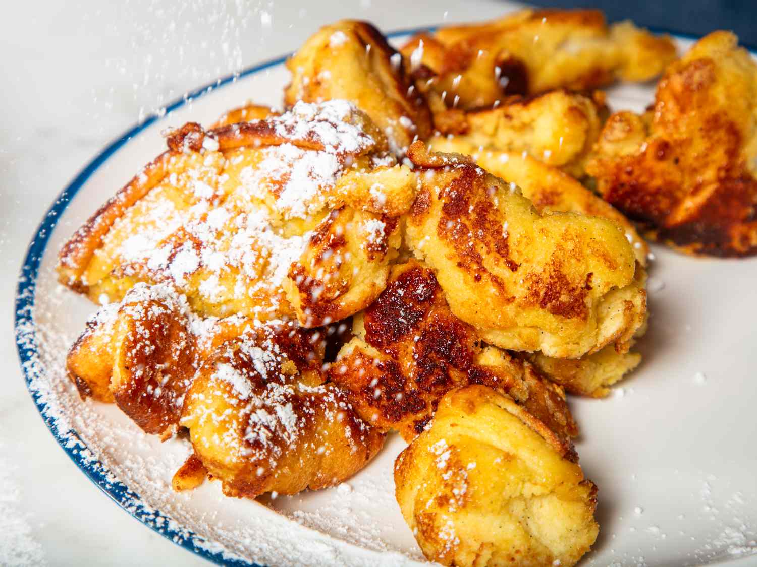 Plate of Kaiserschmarrn with powdered sugar