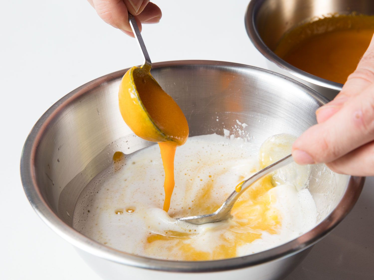 Stirring aji amarillo paste into lime juice for tiradito.