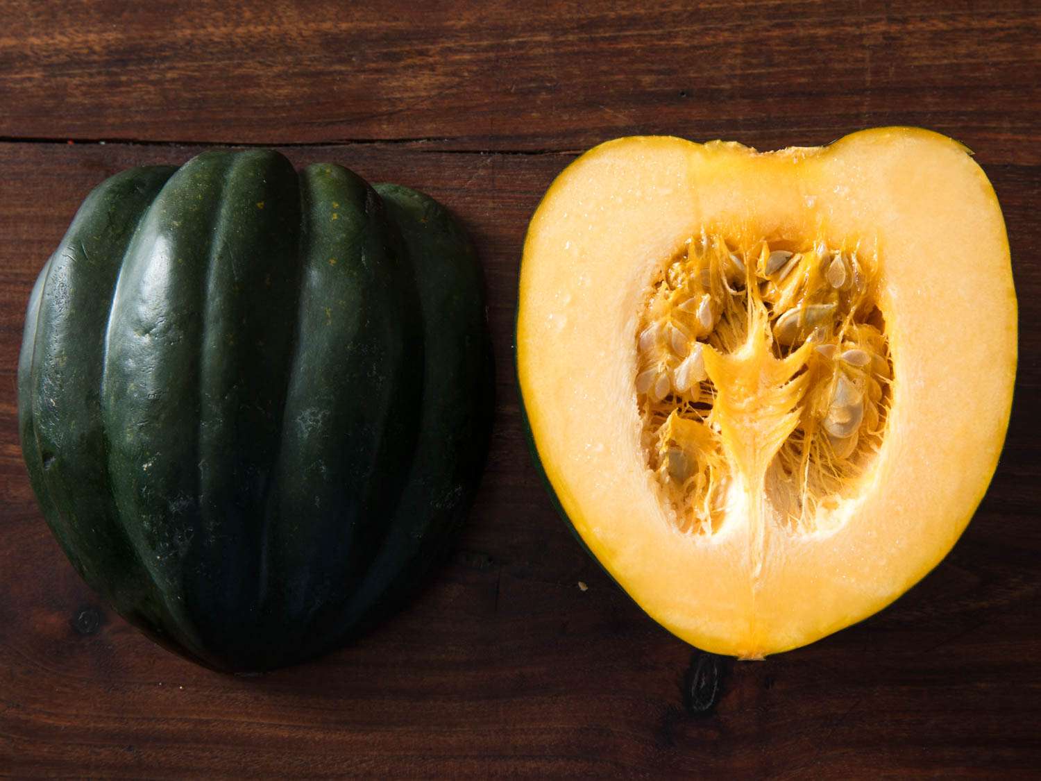 Acorn squash halved and displayed cut side down and cut side up