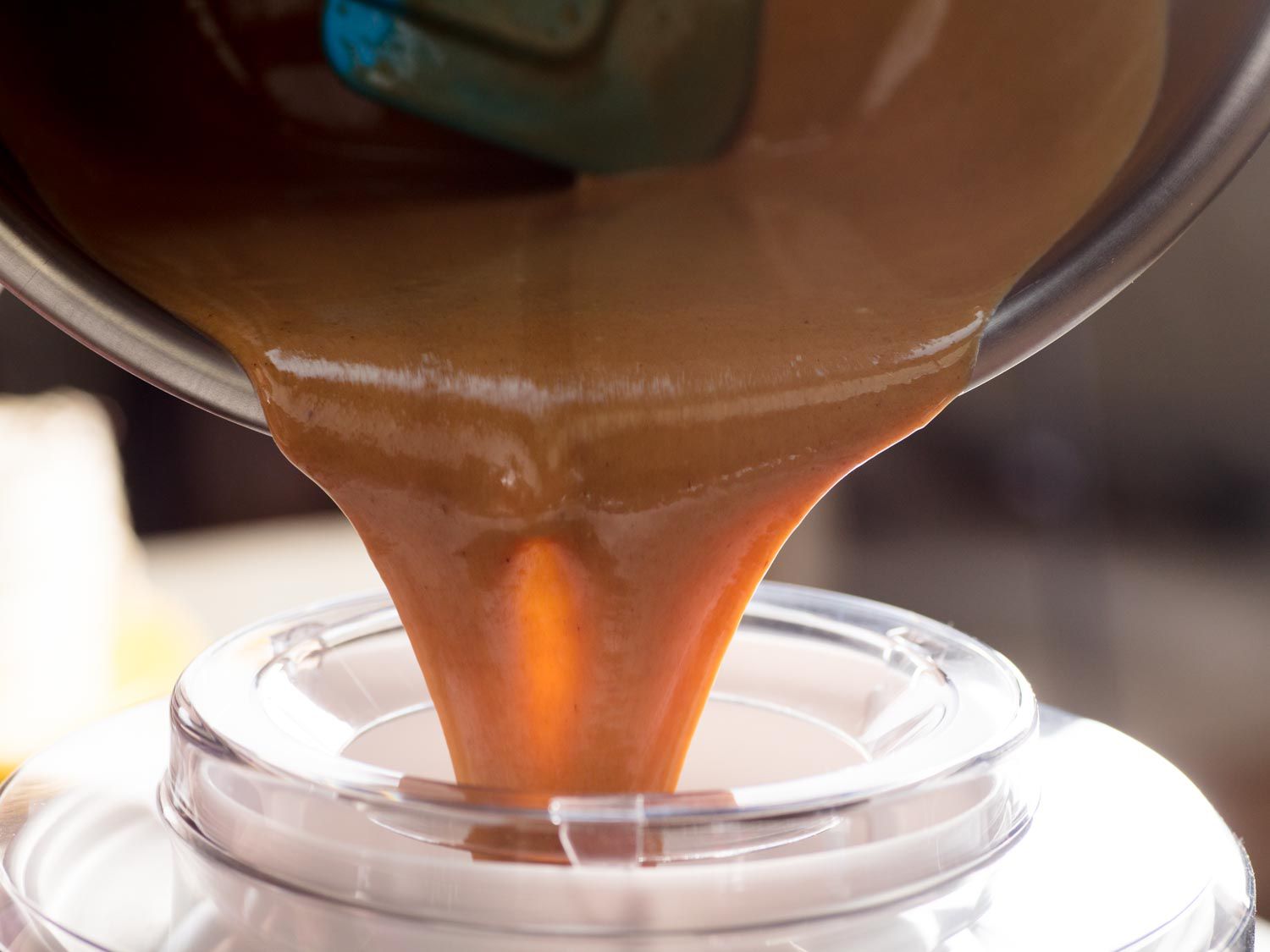 The ice cream base is poured into an ice cream maker.