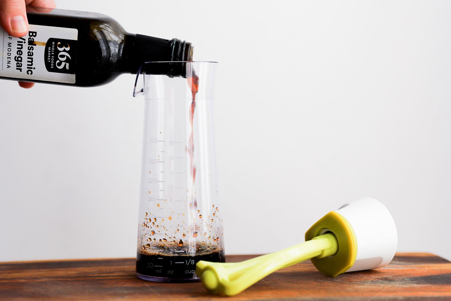 balsamic vinegar being poured into the Emulstir Salad Dressing Mixer