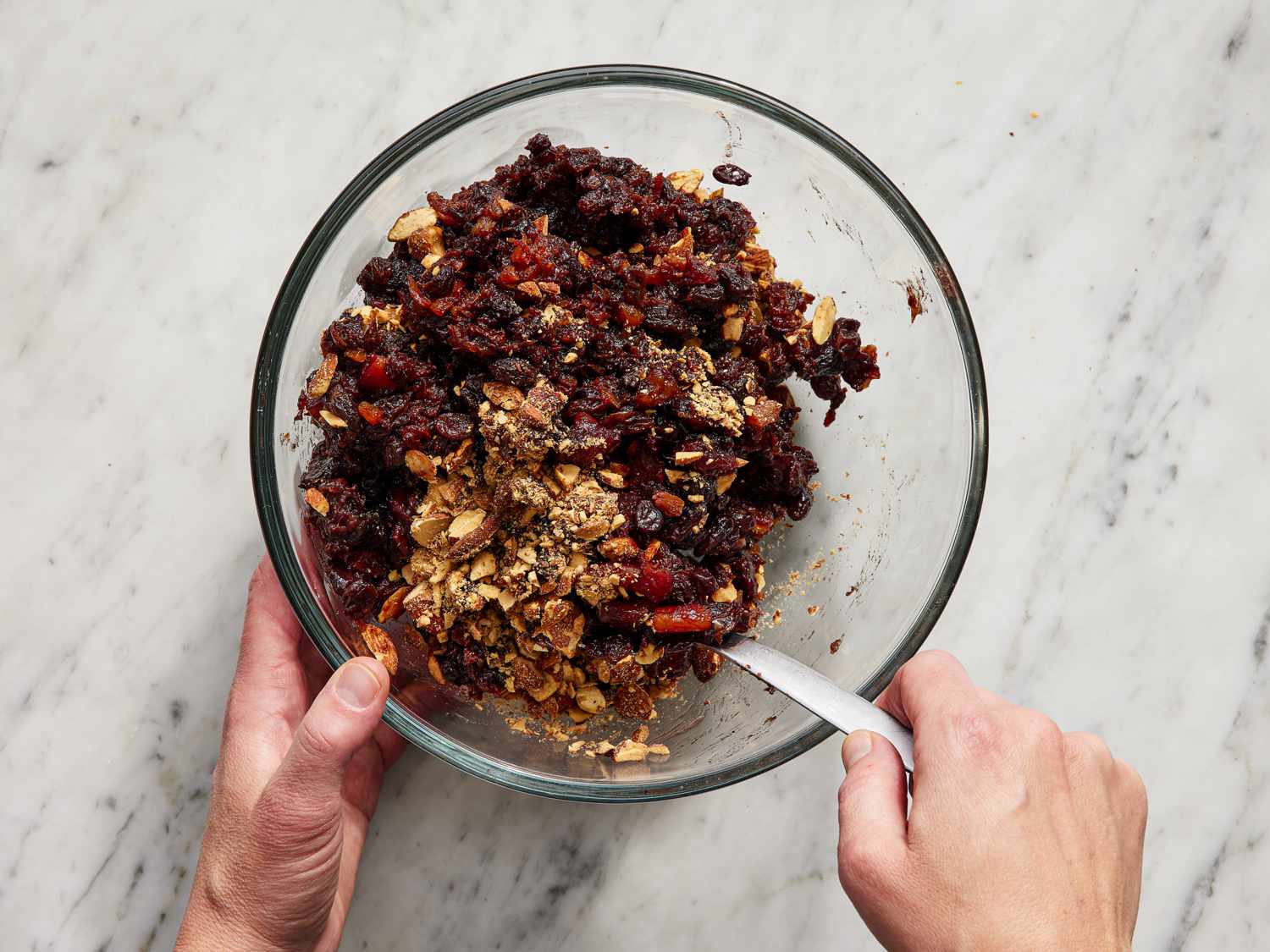 Mixing charoset together in a glass bowl