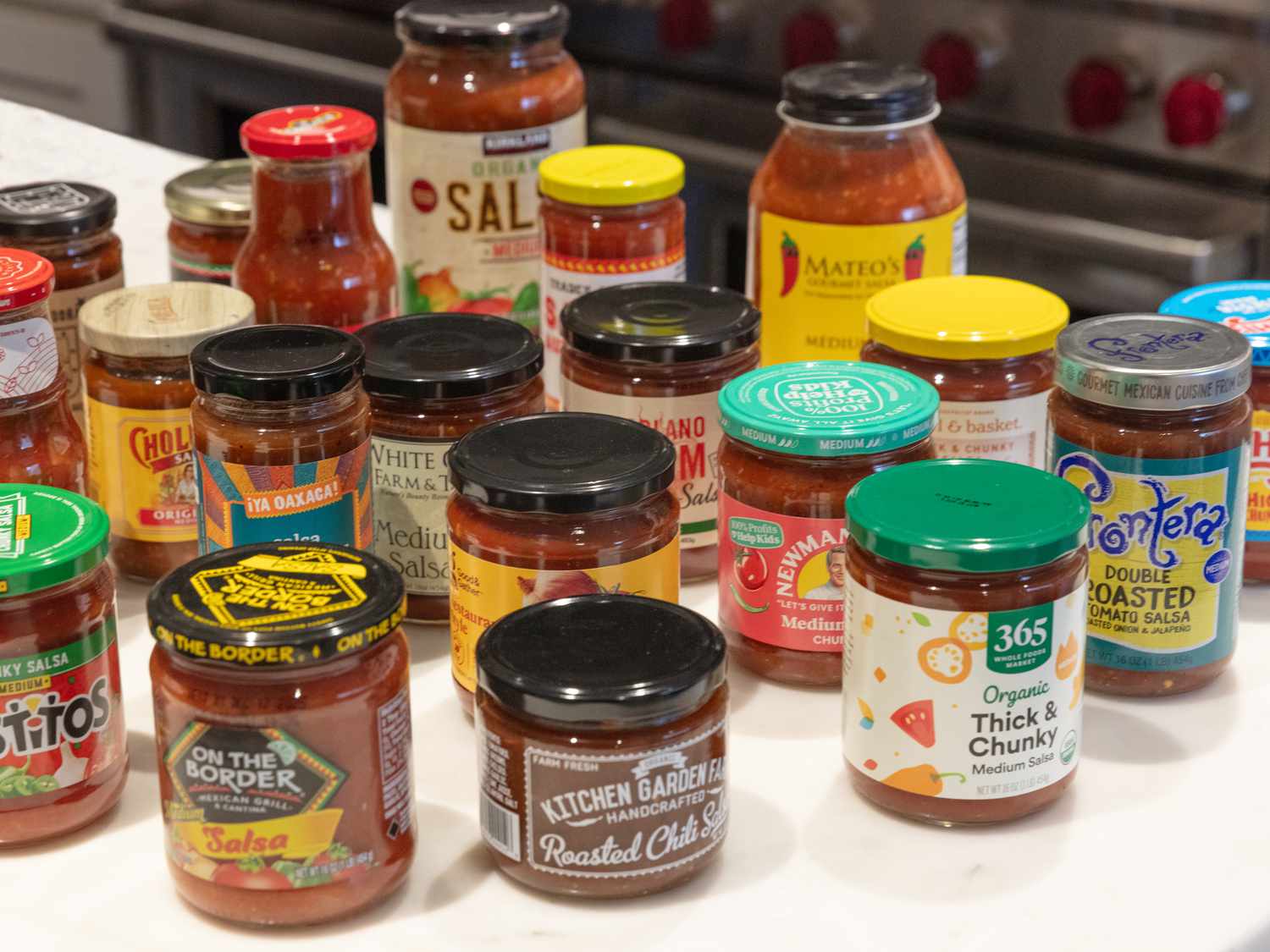 Various jars of salsa arranged on a counter
