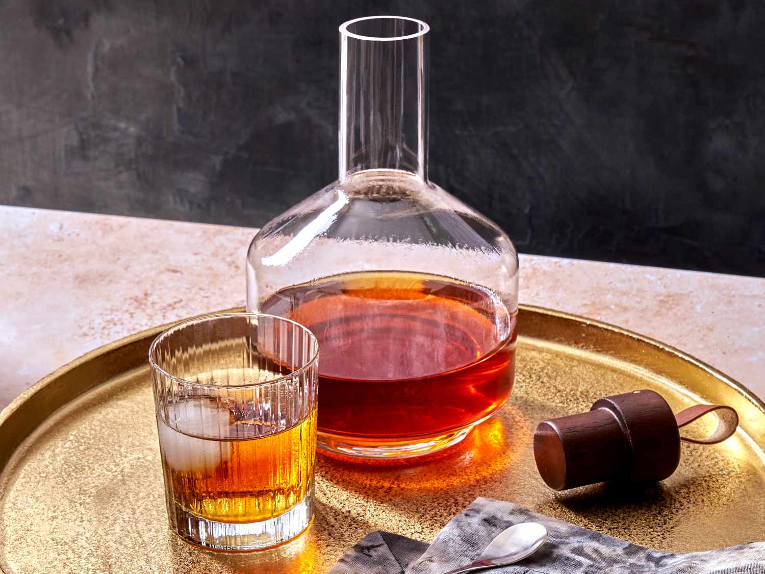 spiced rum in a glass with a decanter filled with the full batch