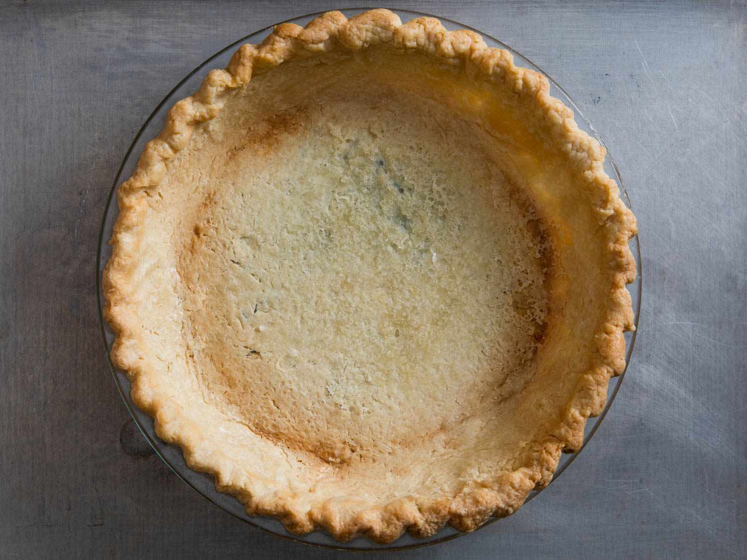 a pie crust blind-baked in a glass pie dish