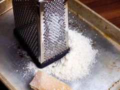 A box grater with grated parmesan 