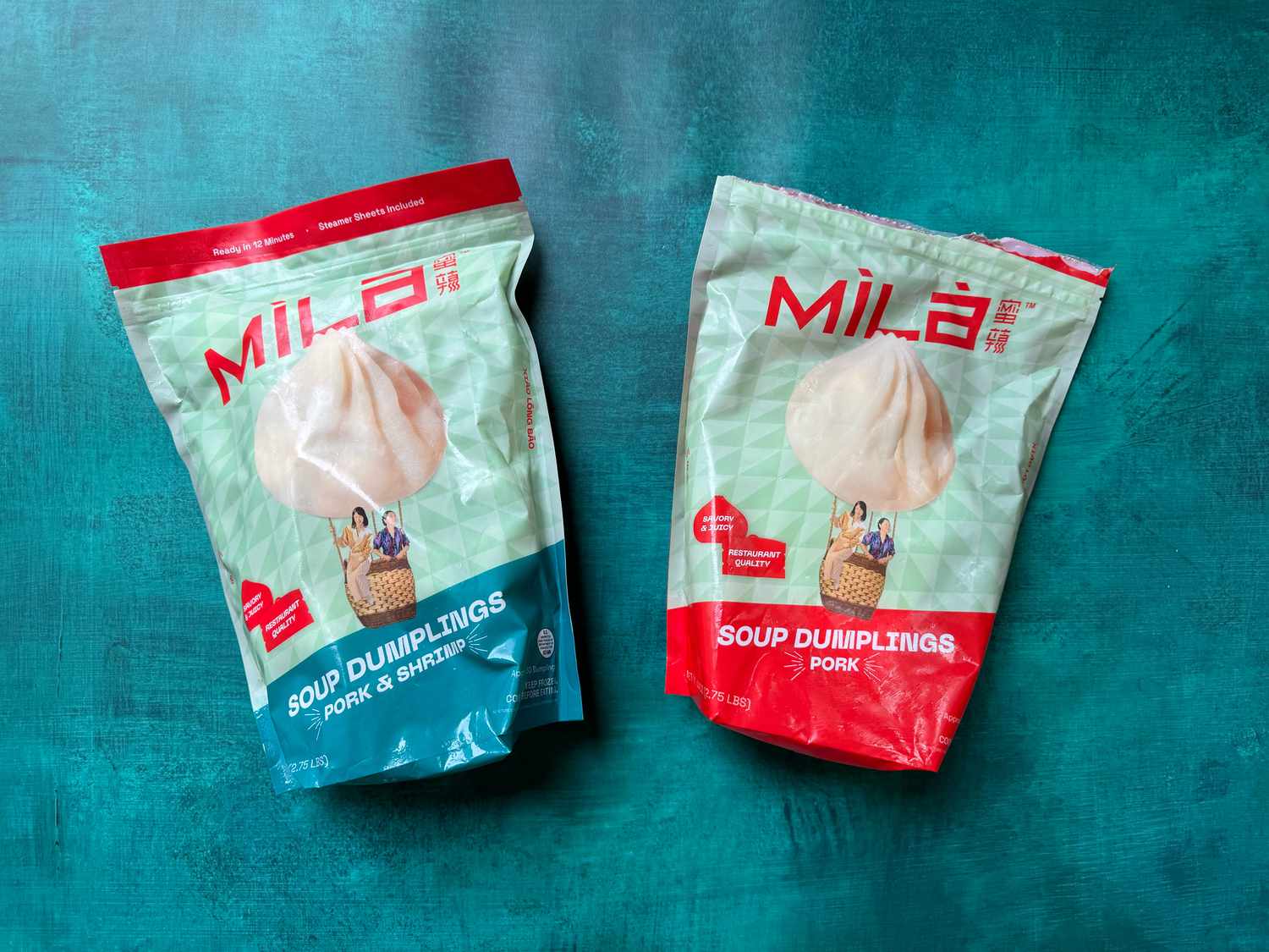 Two bags of soup dumplings on a blue surface