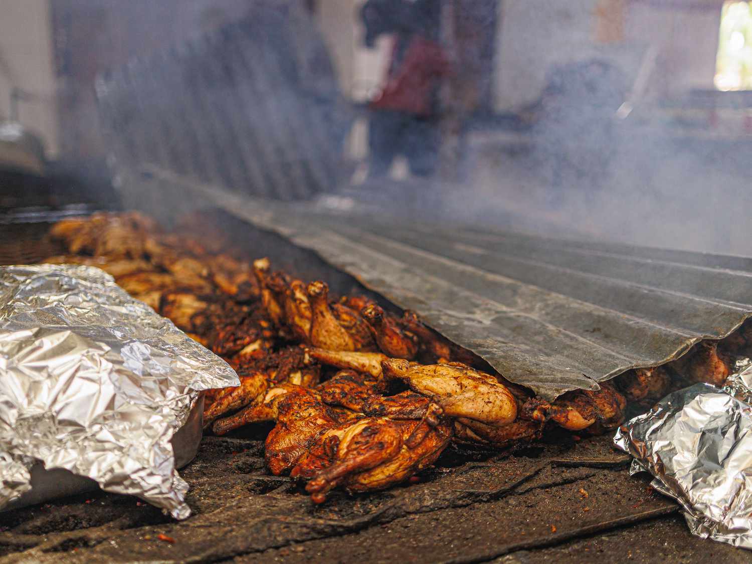 Chicken cooking on a grill at Peppa Thyme Restaurant 