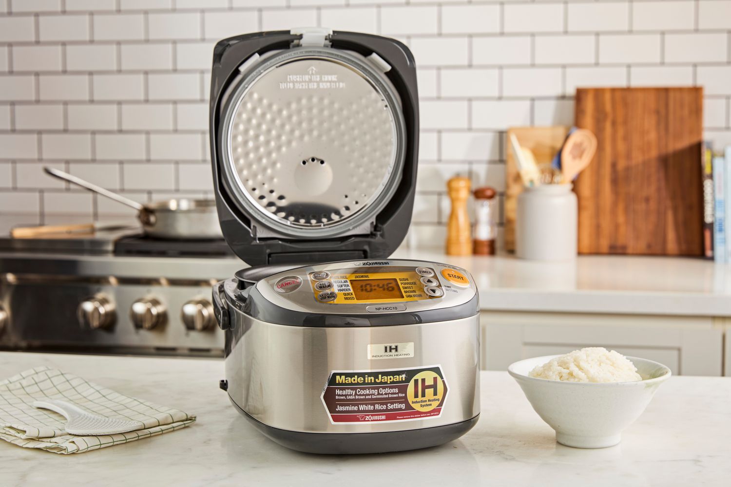 The Zojirushi rice cooker with its lid open.