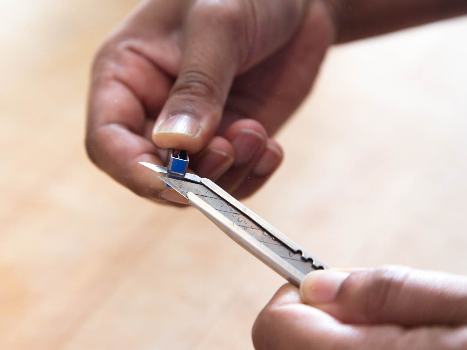 Snapping off a portion of used blade from the end of a utility knife