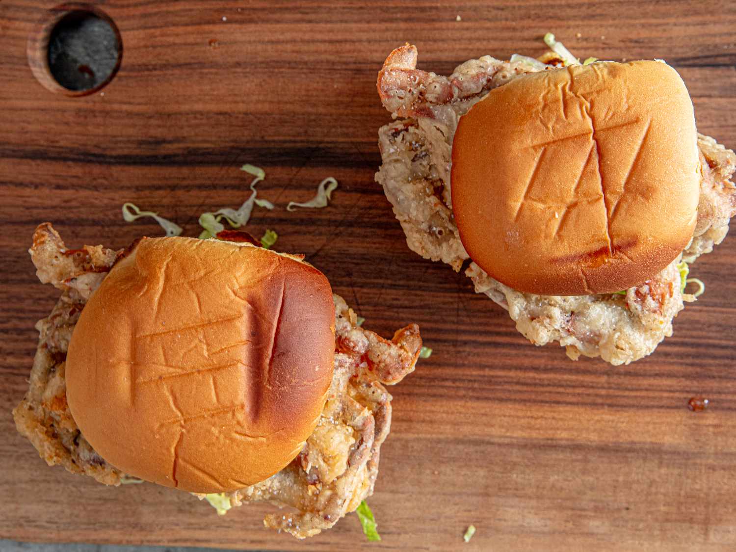 Overhead view of crab sandwiches on buns.