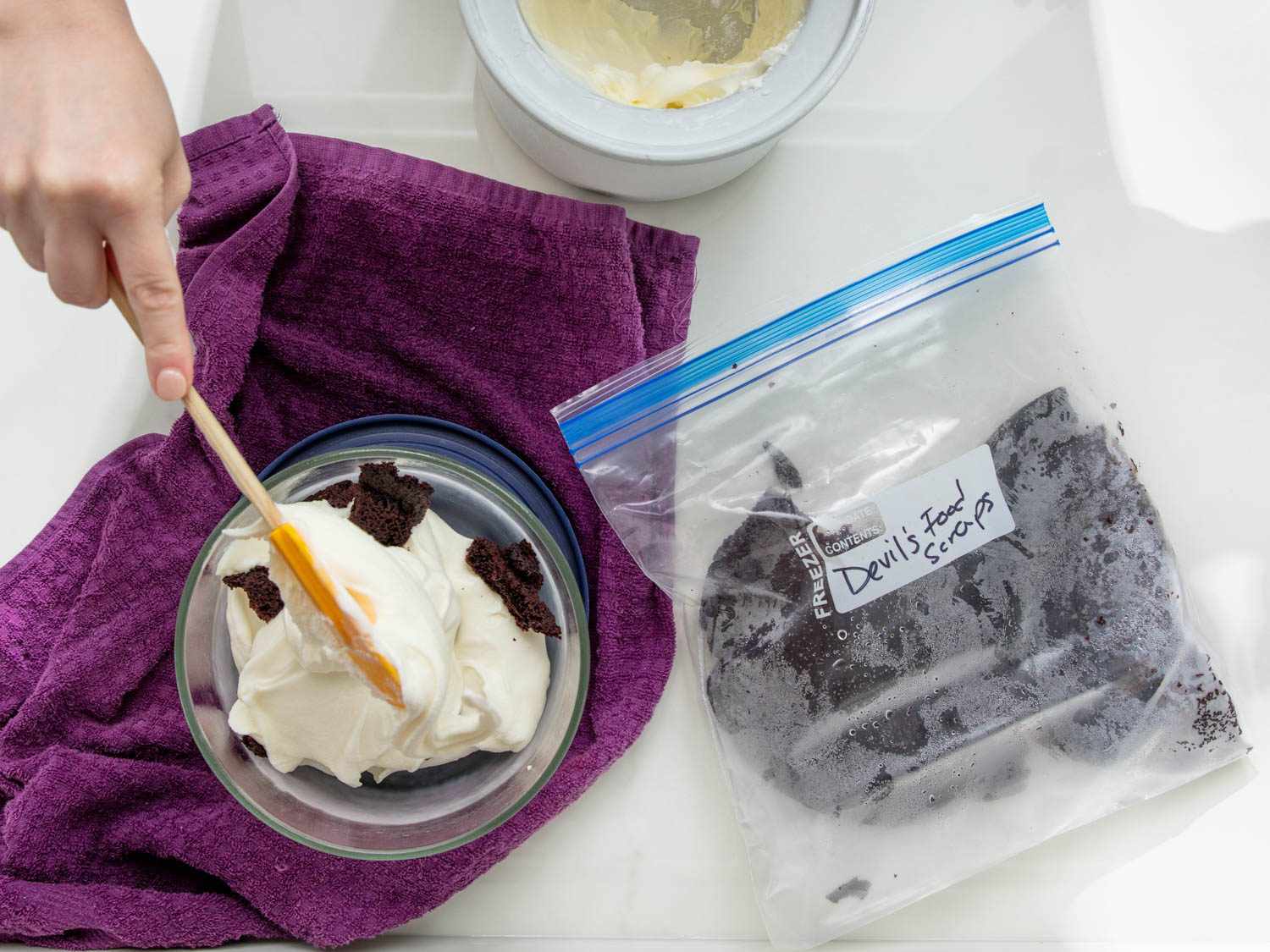 Overhead shot of freshly churned ice cream, with a bag of frozen cake scraps to the side.