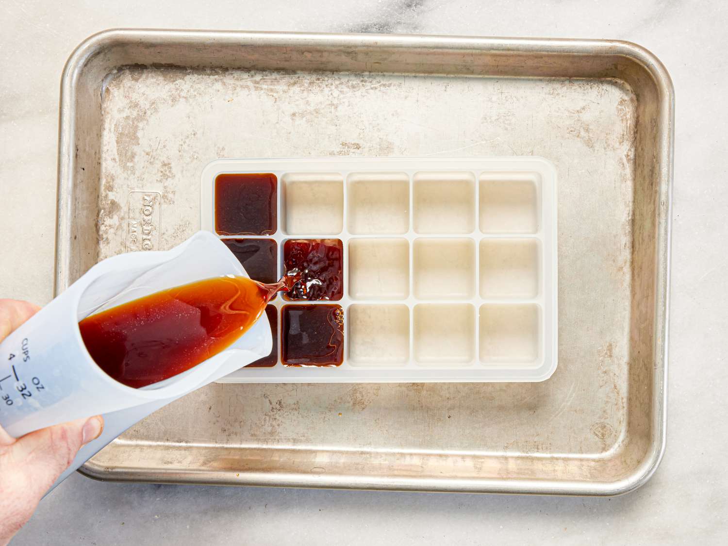 Overhead view of filling ice cube trays