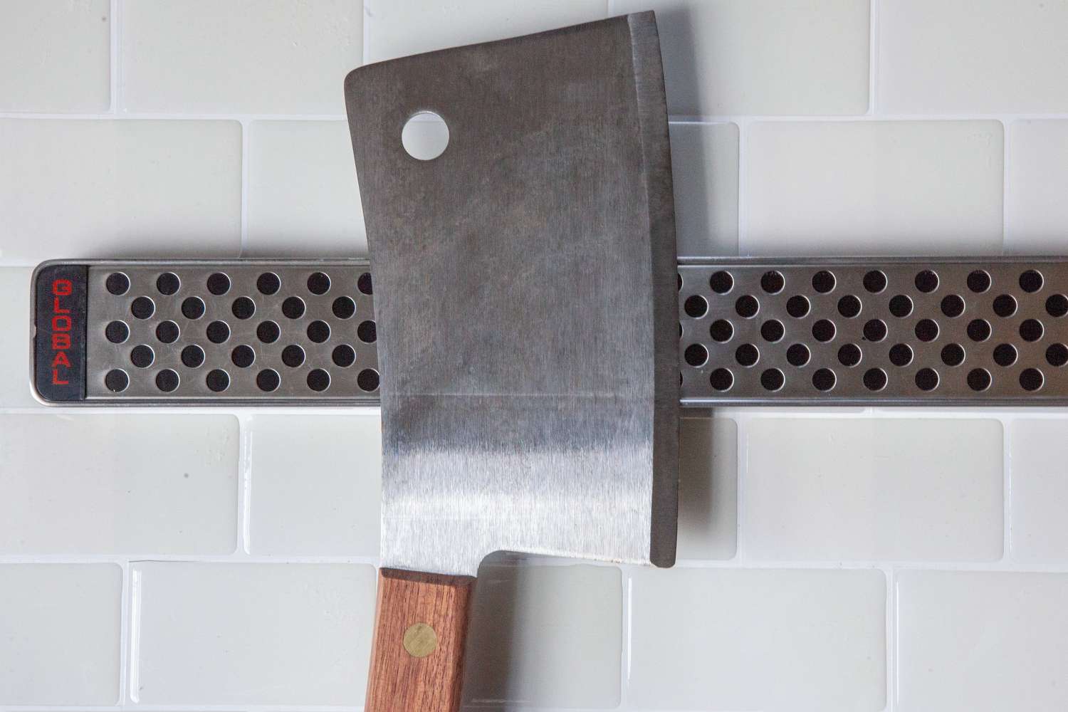Closeup of cleaver attached to Global Magnetic Knife Strip