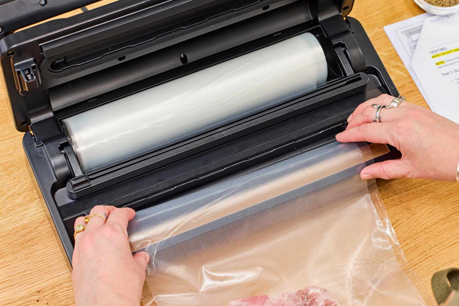 A plastic bag roll is loaded into the Anova Precision Vacuum Sealer Pro