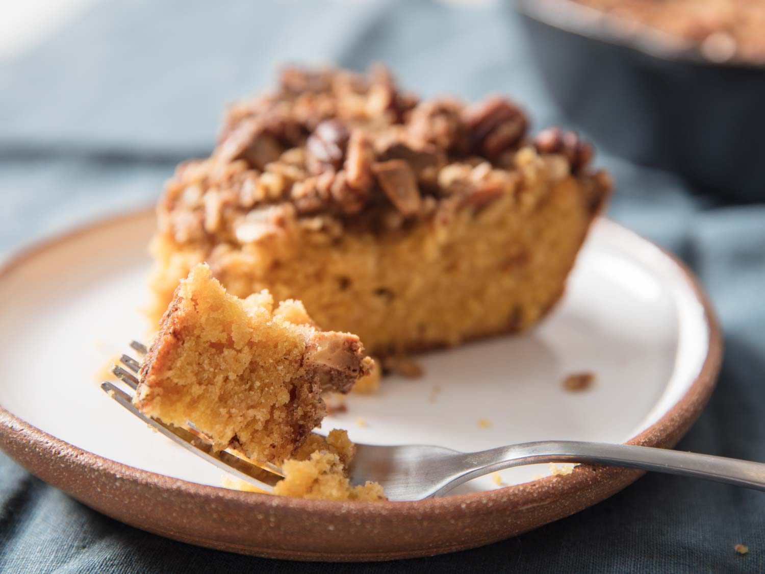 Forkful of plated slice of pumpkin skillet coffee cake.