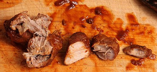 Cuts of carne adovada pork resting on a cutting board.