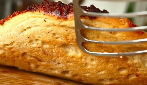 Lifting up a pizza crust with a fish spatula. 