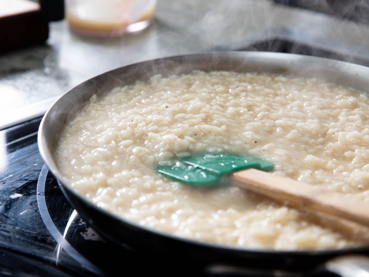 Creamy risotto cooking in a wide skillet