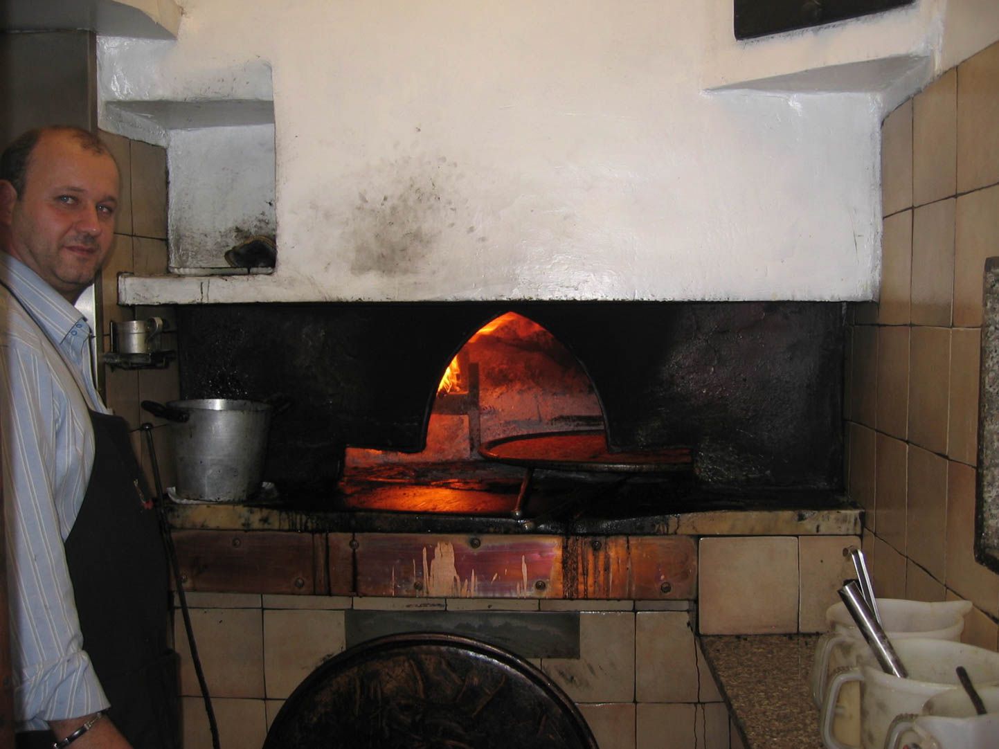 Cooking farinata in a wood-fired oven in Acqui Terme, Italy.