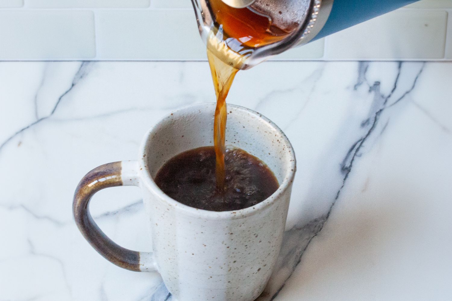 Coffee being poured from the Yeti French Press into a mug