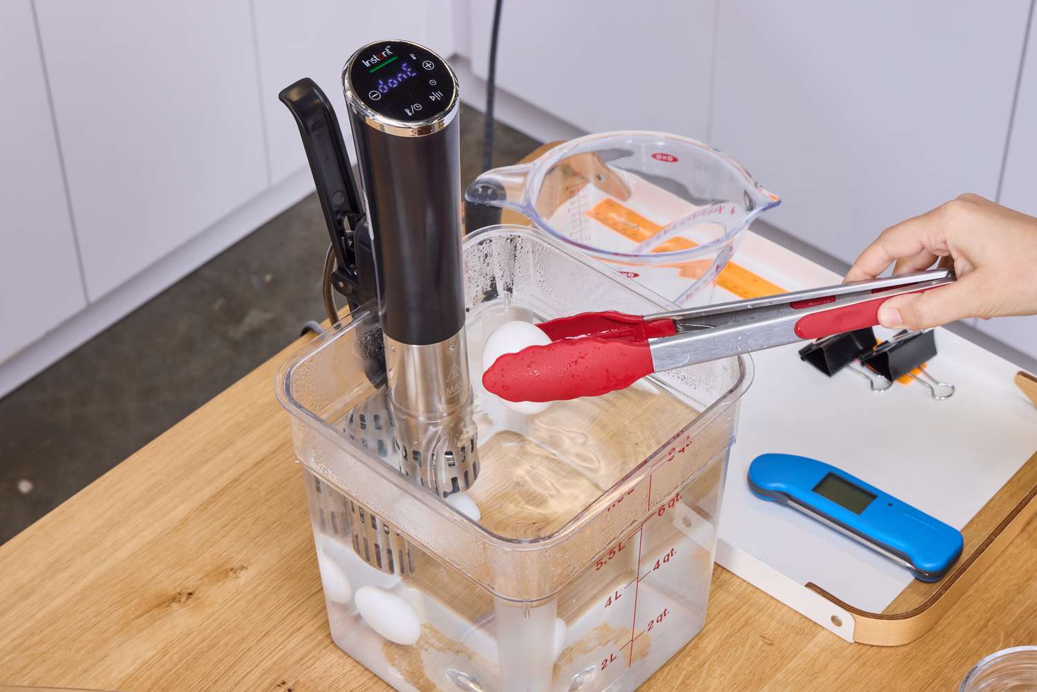 A person removes eggs from the Instant Accu Slim Sous Vide Immersion Circulator