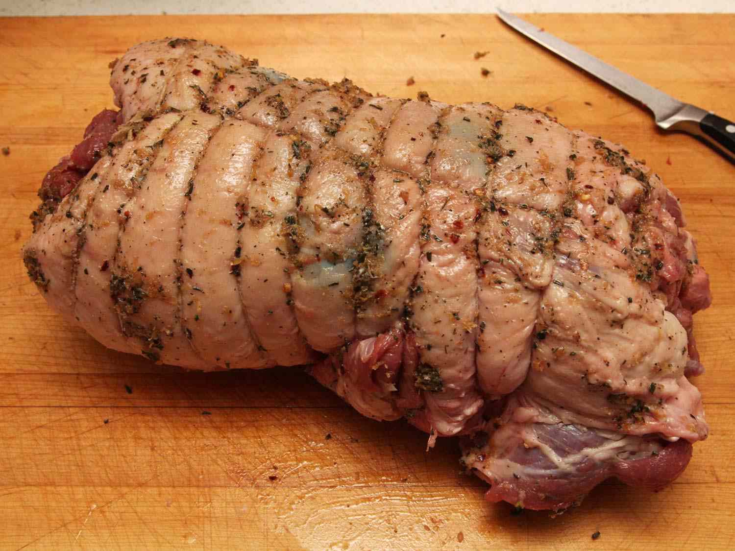 A tied and seasoned boneless leg of lamb, ready for the oven.