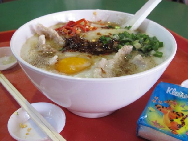 A bowl of sliced pork congee at a Singaporean food court.