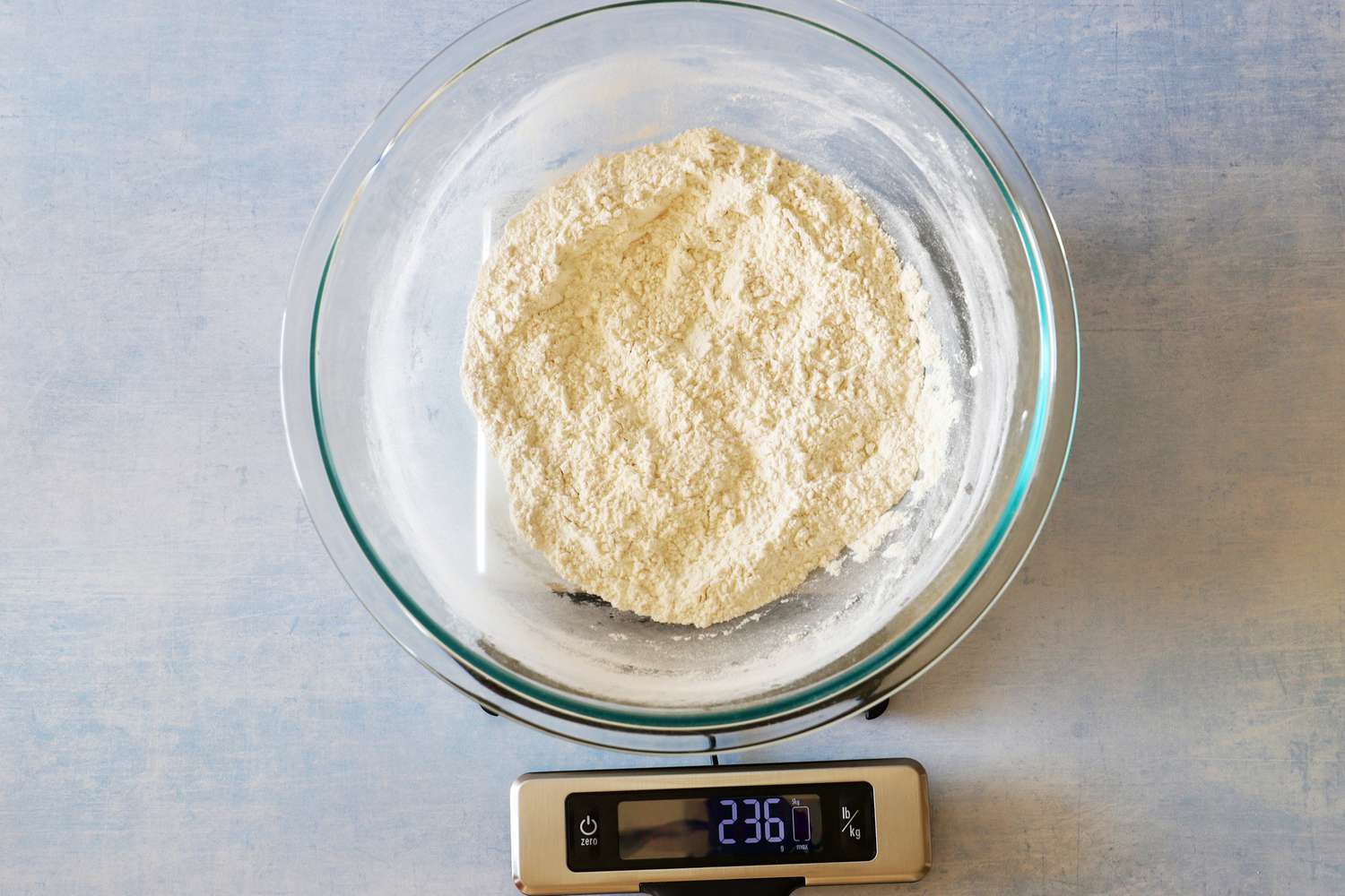 A large bowl of flour on the OXO kitchen scale with its display pulled out.