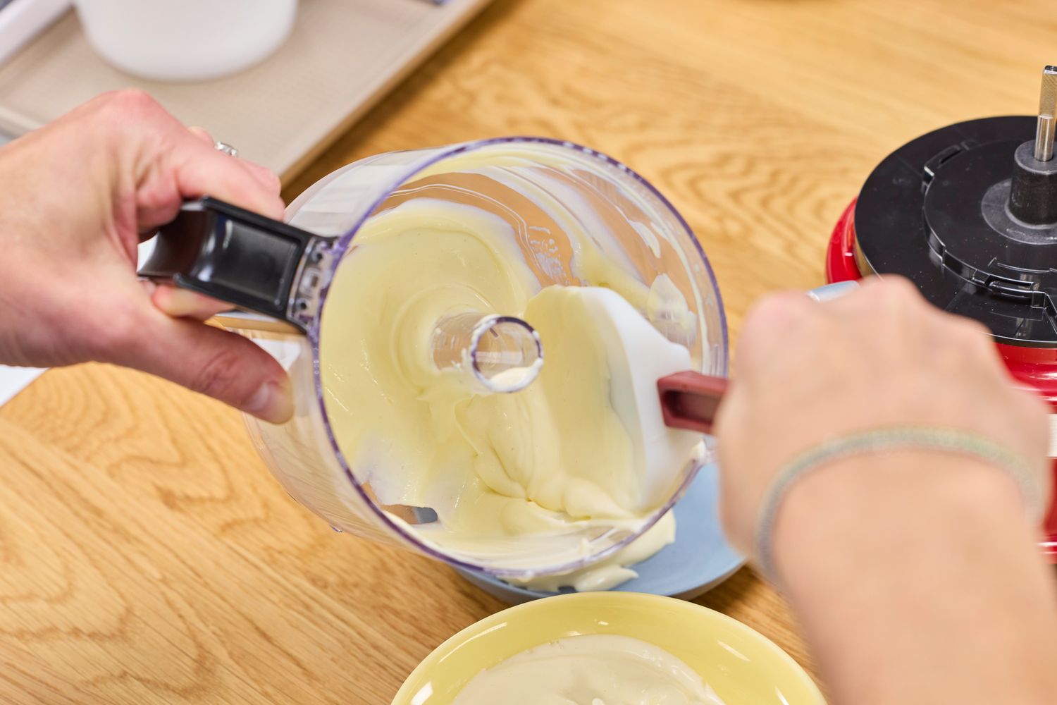 White sauce made int he KitchenAid 3.5-Cup Food Chopper is poured into a bowl