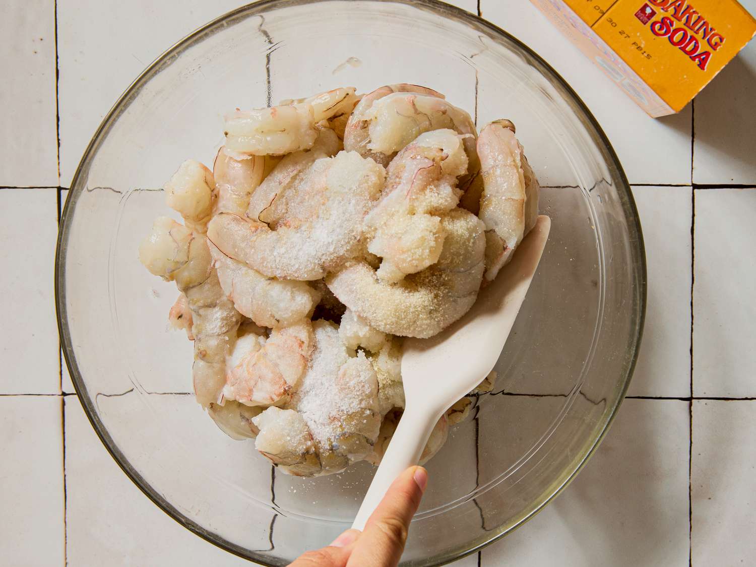 Bowl of shrimp being stirred or prepared with a utensil