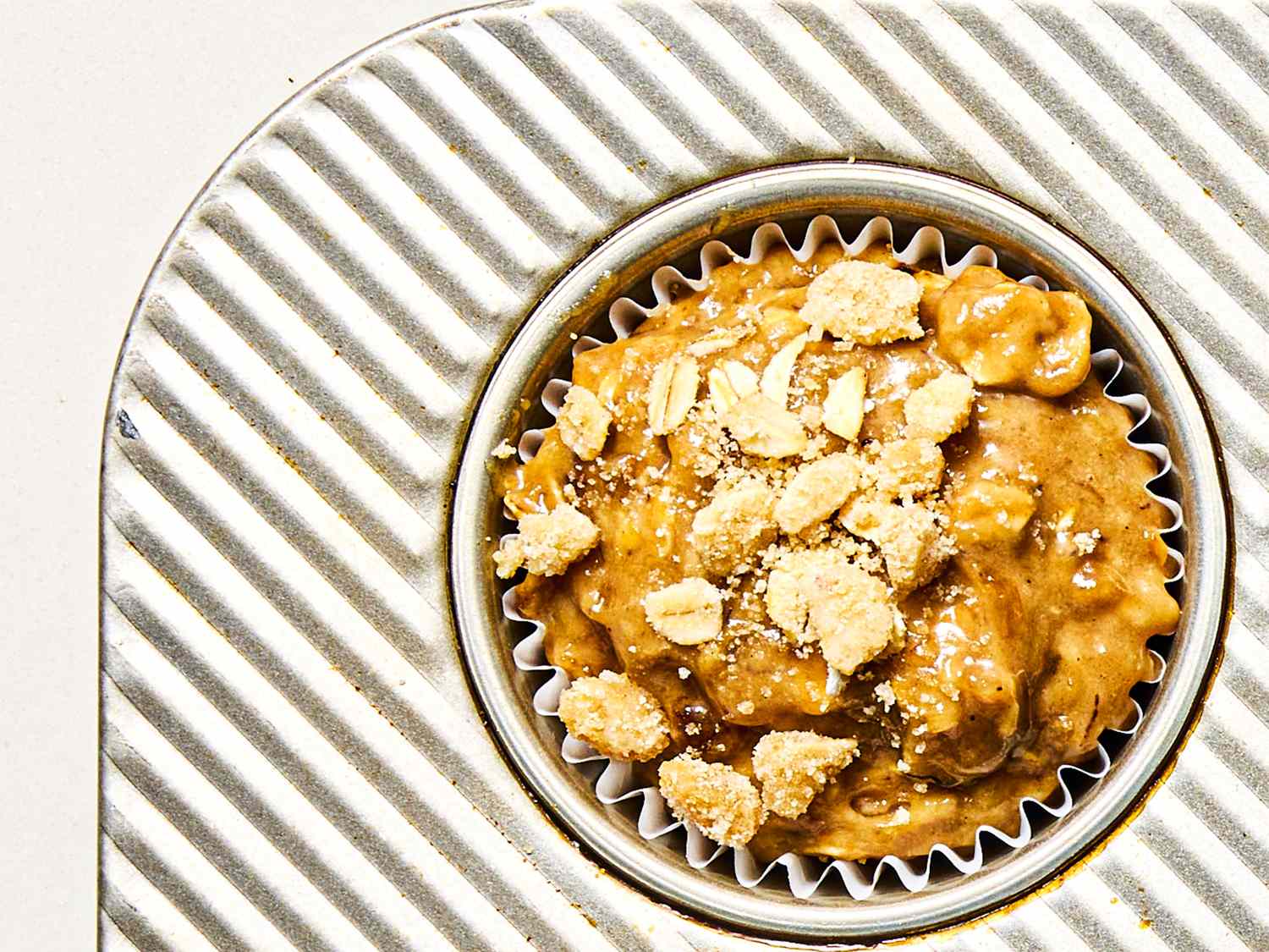 Overhead view of a banana nut muffin before being baked