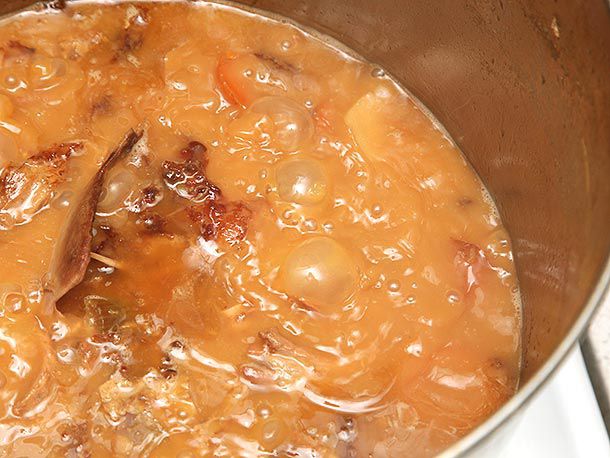 Close up of brown turkey stock on a rolling boil. 