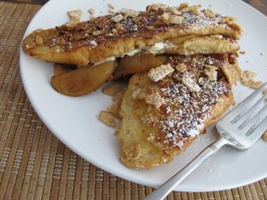Closeup of Cinnamon Toast Crunch® Coated Apple Stuffed French Toast, served on a white plate.
