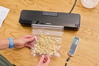 A bag of cereal is vacuum sealed using the Anova Precision Sous Vide Vacuum Sealer