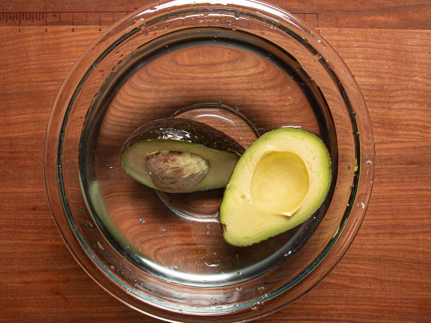Overhead view of avocados submerged in water