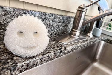 The Scrub Daddy dishwashing sponge next to a kitchen sink
