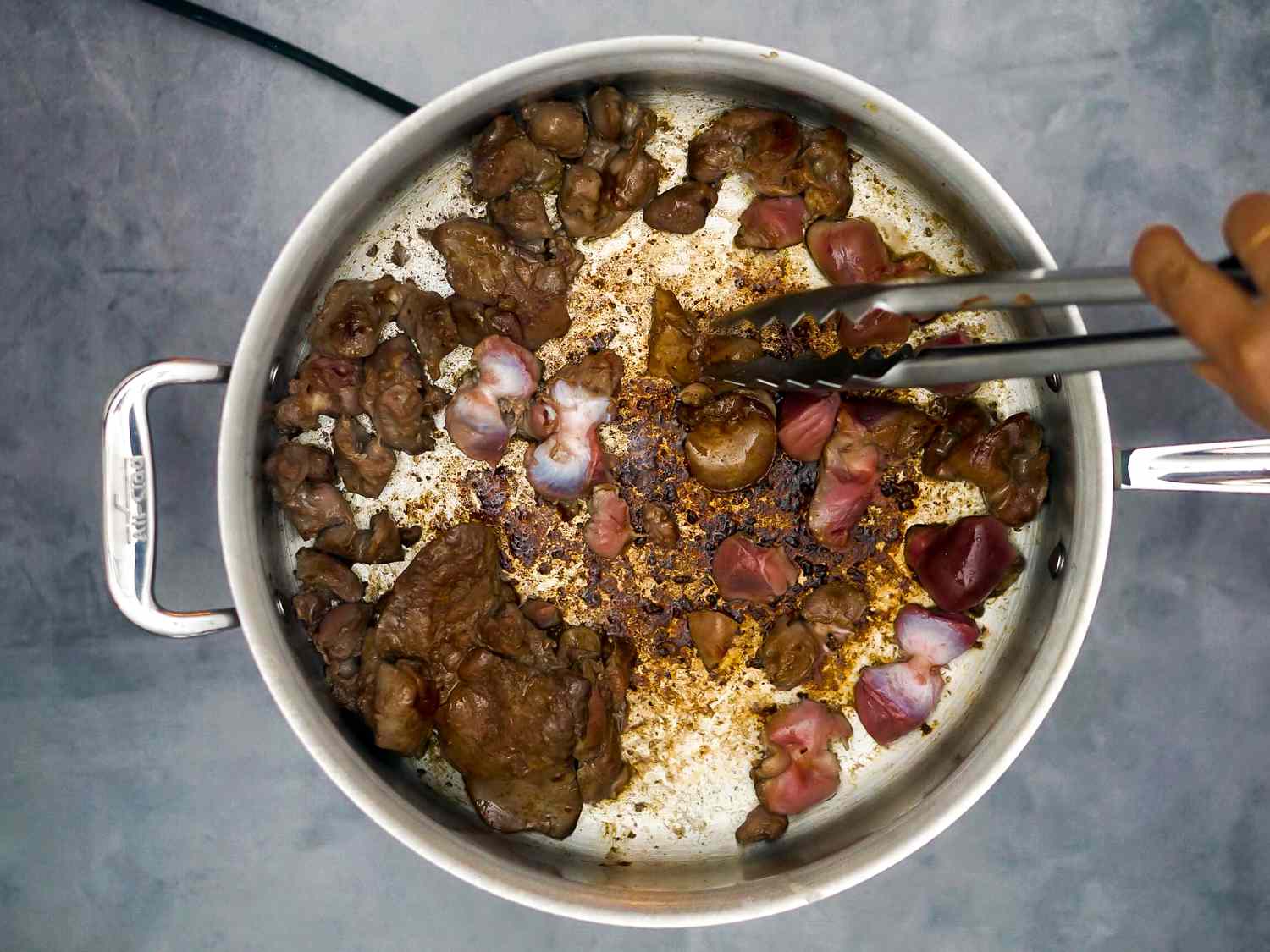 chicken giblets browning in a pan
