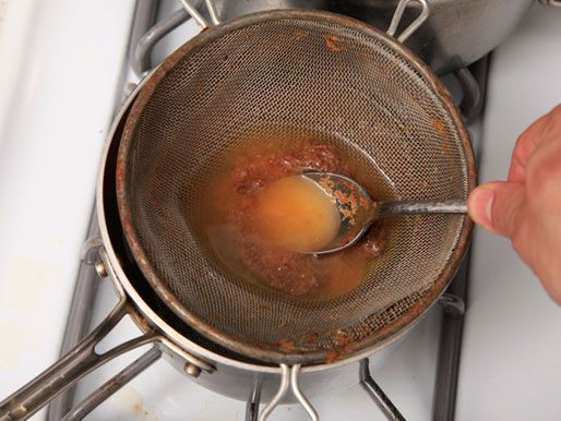 Pressing miso paste broth through a sieve for a pot of easy miso soup.