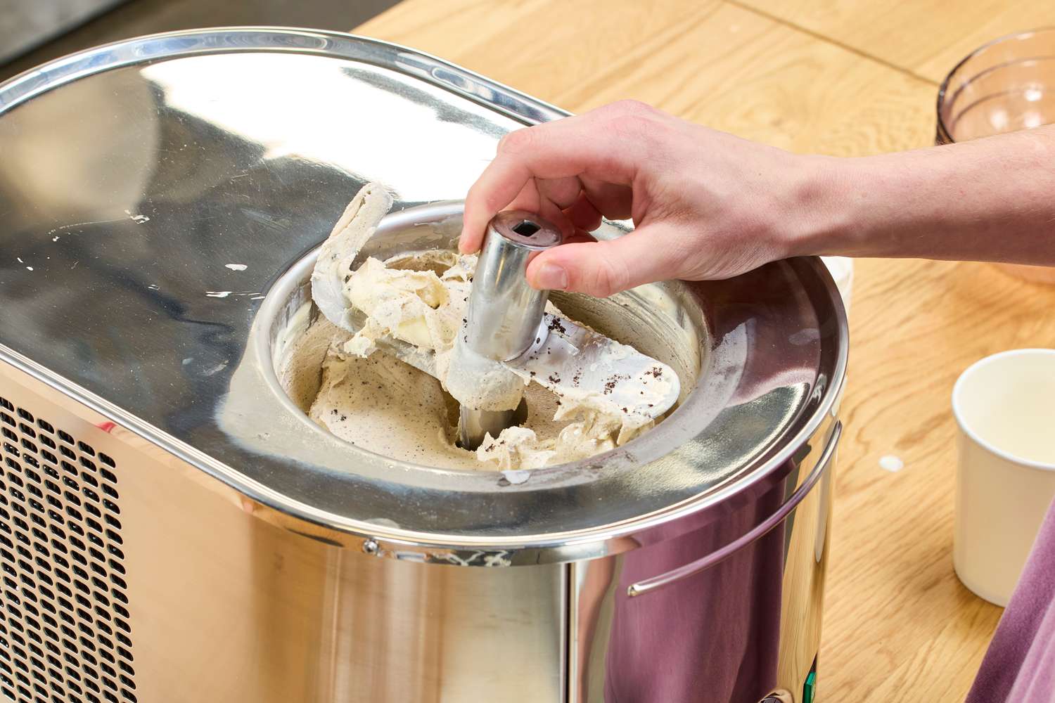A person removing part of the Lello Musso Lussino 4080 Ice Cream Maker