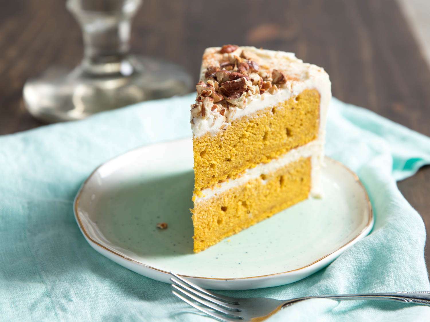 A slice of pumpkin layer cake, served on a small plate.