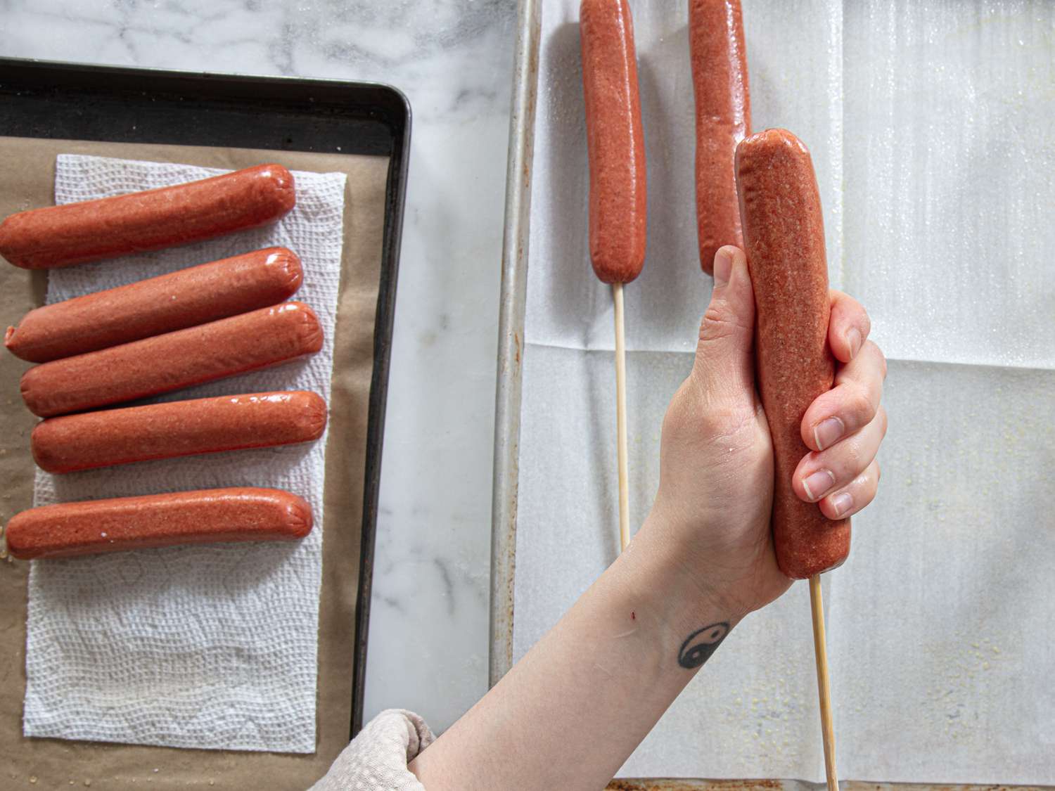 Overhead view of skewering hot dogs