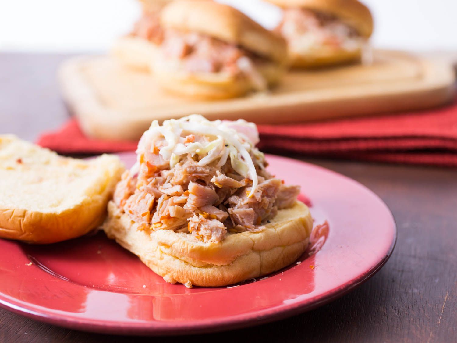Open smoked turkey barbecue sandwich topped with coleslaw.