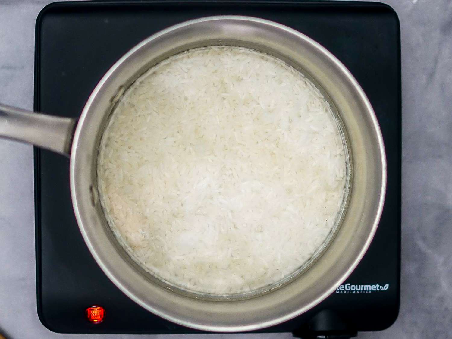 white rice added to pot and covered in water
