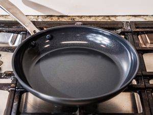 The OXO Non-Stick Pro 10-Inch Frypan on a stove top.