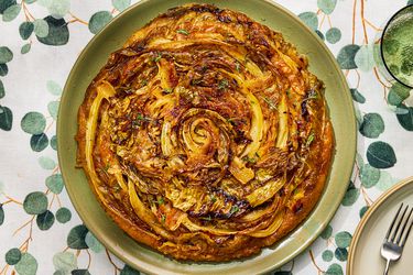 A savory cabbage tart tatin on a green plate