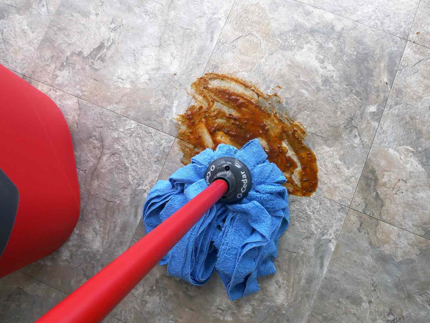 using the o cedar microfiber wet mop to clean up barbecue sauce
