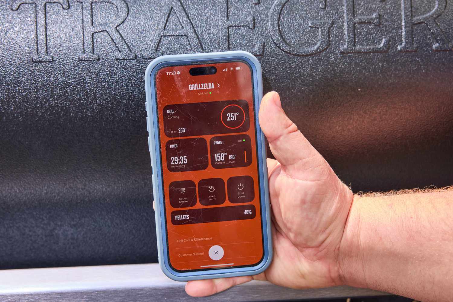 A person controls the Traeger Ironwood XL with their smartphone