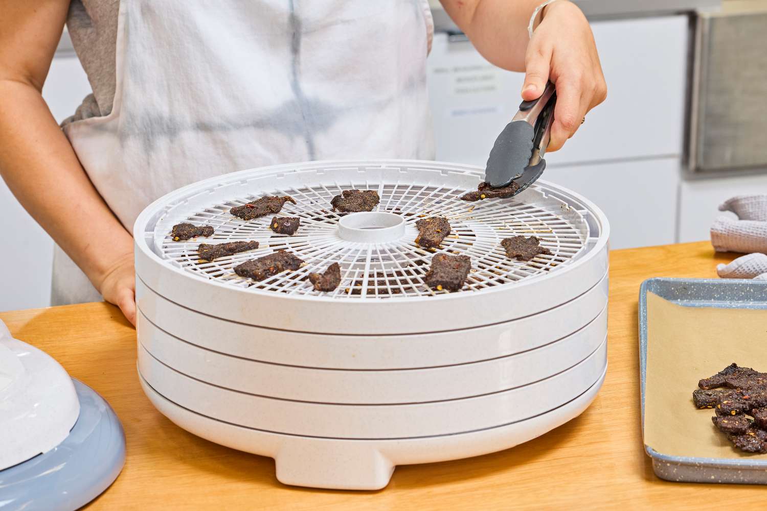 A person testing Nesco Gardenmaster Digital Pro Food Dehydrator