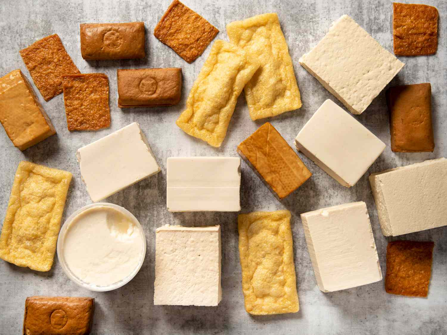 An overhead shot of many different types of tofu.